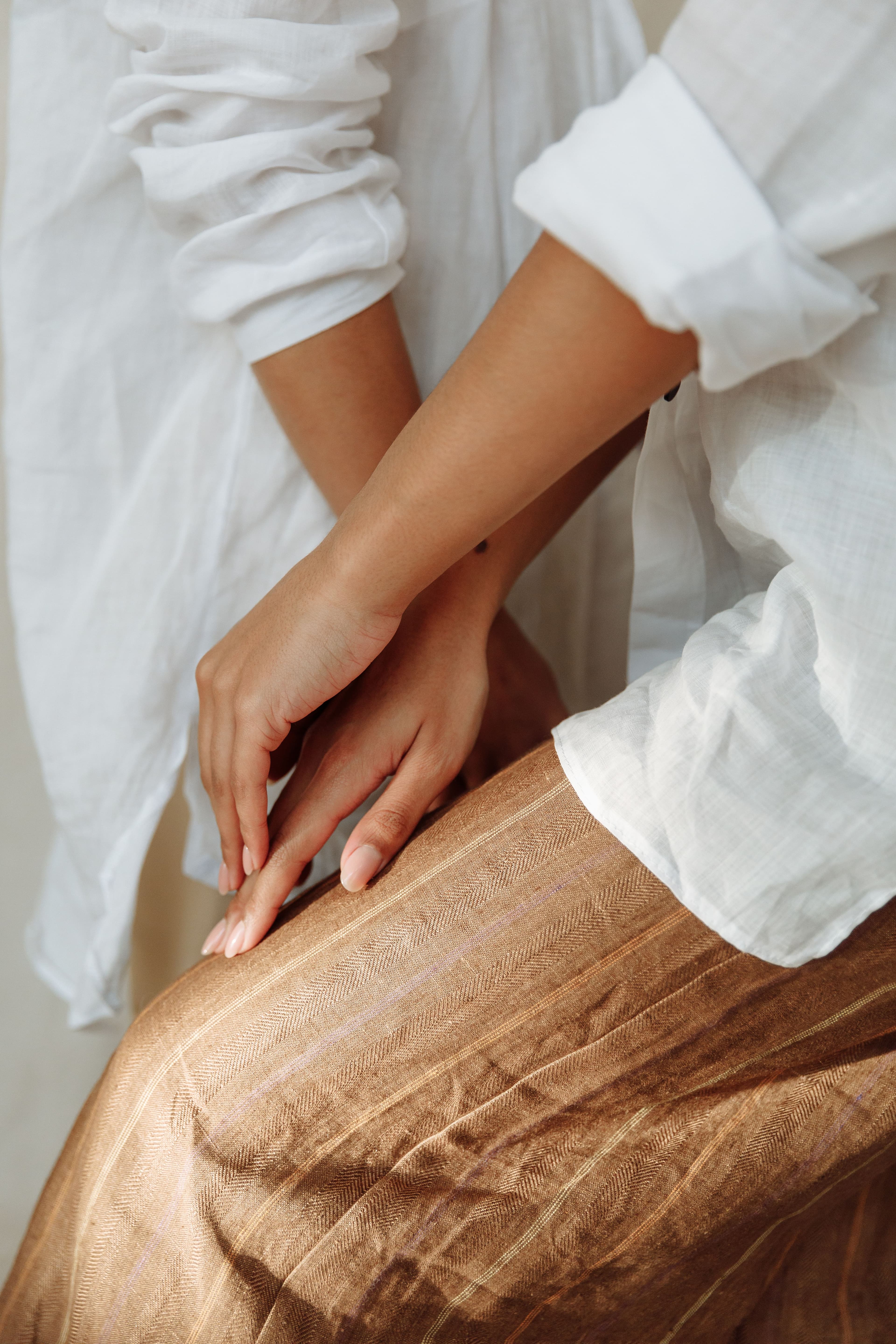 Two people holding hands, offering compassionate support