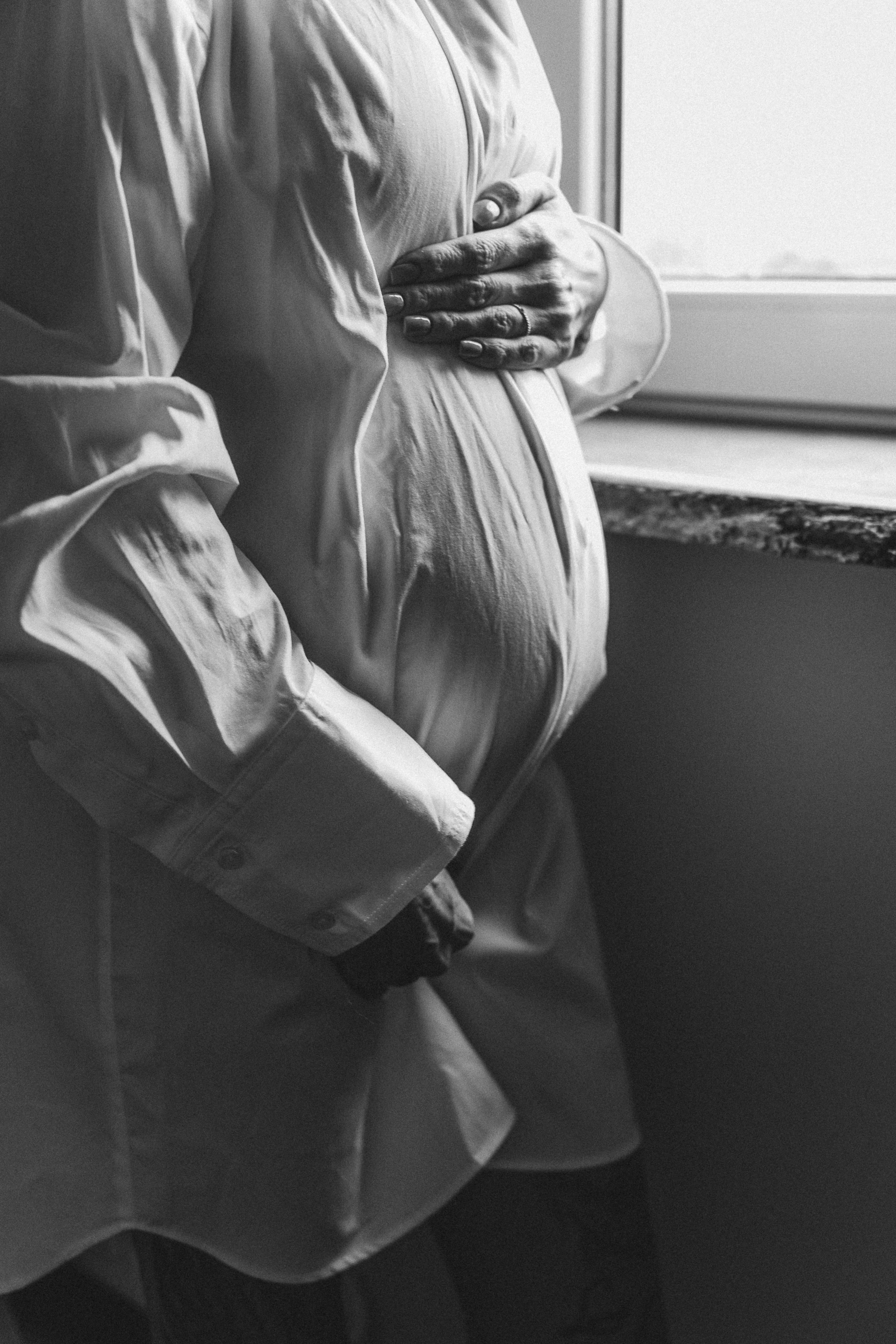 Partner kneeling to comfort and support a pregnant person during labour